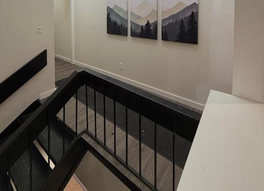 A hallway with a black railing at The Retreat at Walnut Creek, Columbus , OH, Ohio