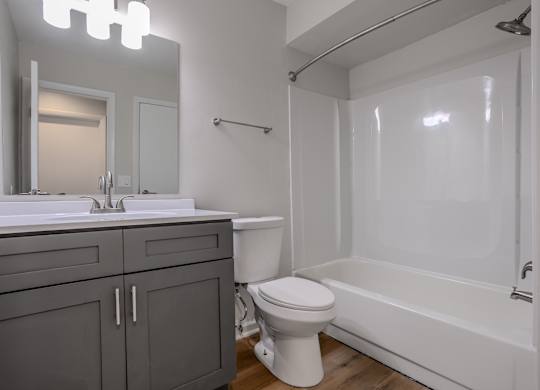 A white toilet sits next to a white sink in a bathroom. at Commons At Waters Edge, Columbus Ohio