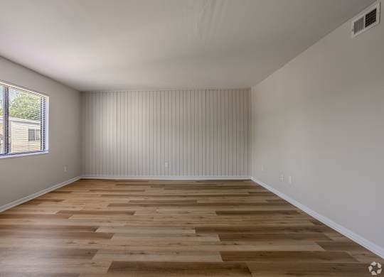 A room with wooden flooring and a window with blinds. at Commons At Waters Edge, Columbus Ohio