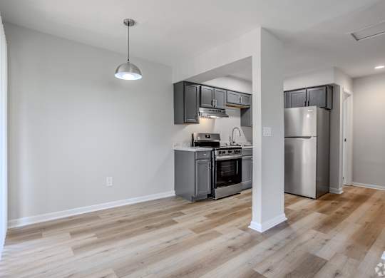 A kitchen with a refrigerator, oven, and stove. at Commons At Waters Edge, Columbus Ohio