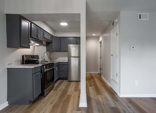  A kitchen with dark wood cabinets and a white countertop. at Commons At Waters Edge, Columbus Ohio