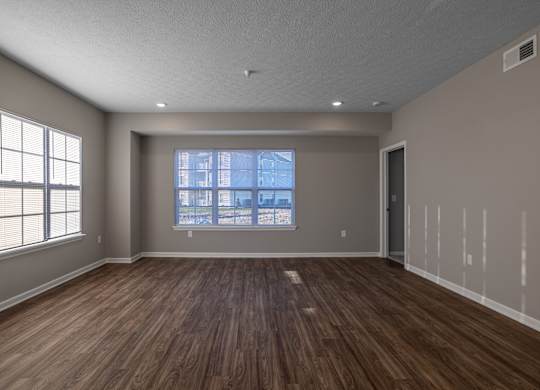 A room with wooden floors and a large window.at The Residences at Akita Lane, Canal Winchester, 43110