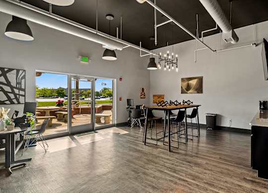 A modern kitchen with a dining table and chairs. at Vivo Toledo Apartments, Ohio, 43607