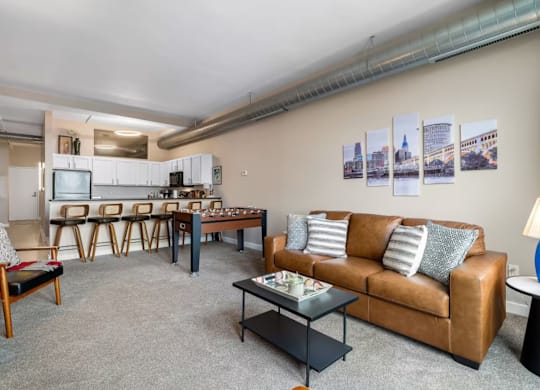 A living room with a brown couch and a coffee table.