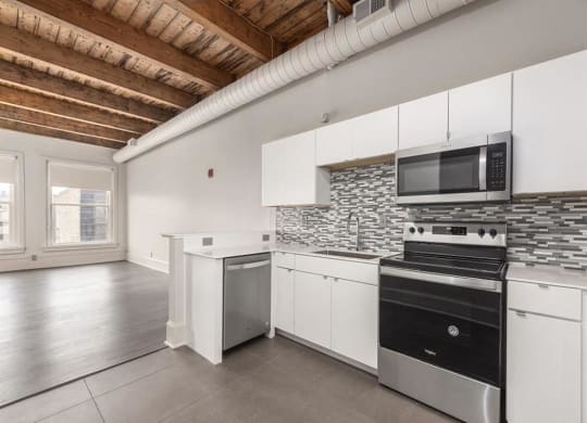 a kitchen with a stove top oven and a microwave