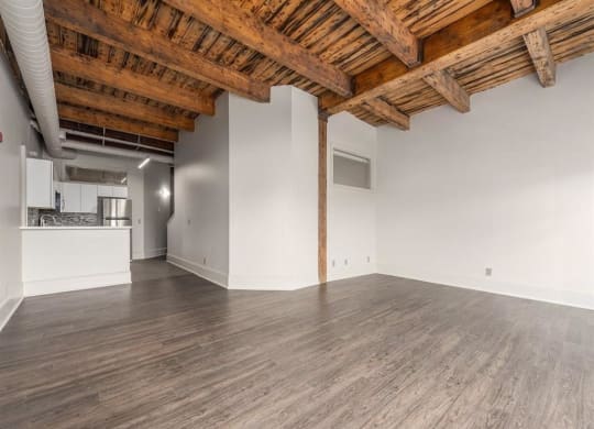 an empty room with white walls and a wooden ceiling