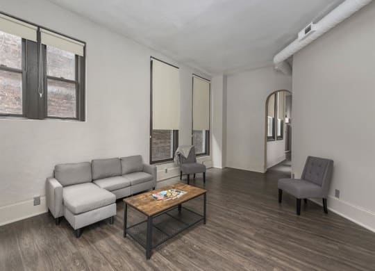 a living room with a couch chairs and a coffee table