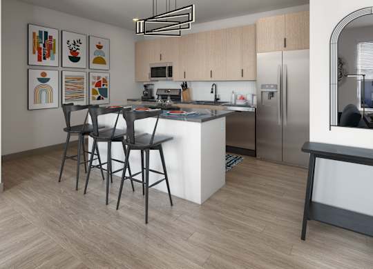 A modern kitchen with a white island and stainless steel appliances.
