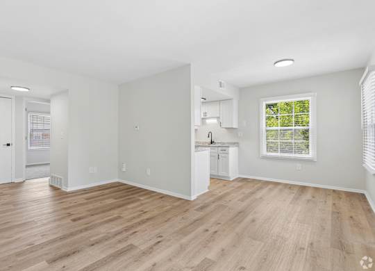 A room with wooden floors and white walls.