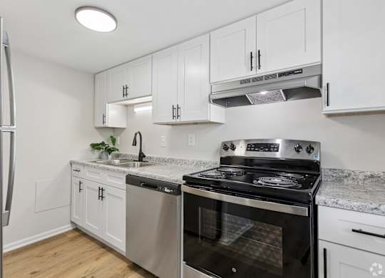 A kitchen with a stove, oven, and refrigerator.