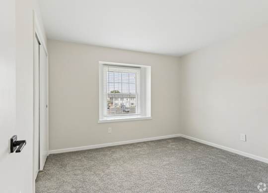 A room with a window and a door.