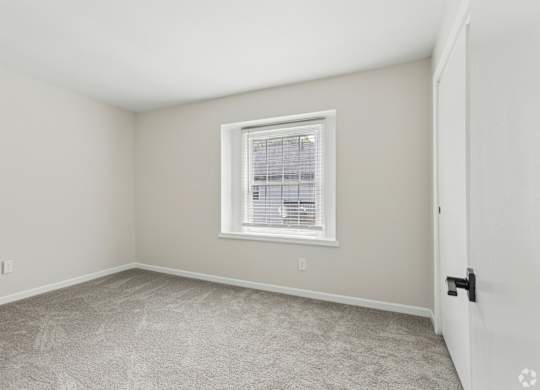 A room with a window and a door.