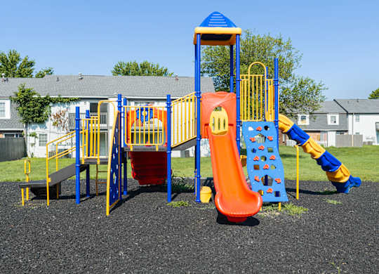 A playground with a slide, swings, and a climbing frame.