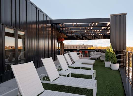 A patio with white chairs and a green lawn at The Park Apartments, Cleveland , OH