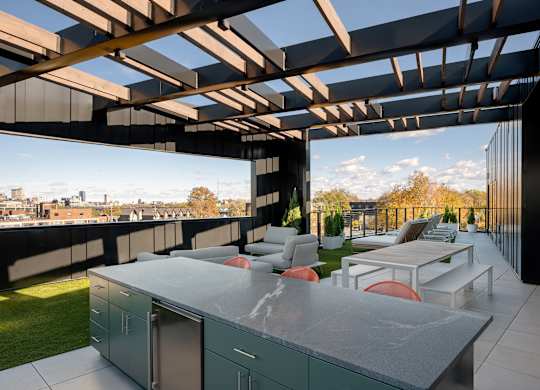 A modern outdoor kitchen with a view of the city at The Park Apartments, Cleveland 44113