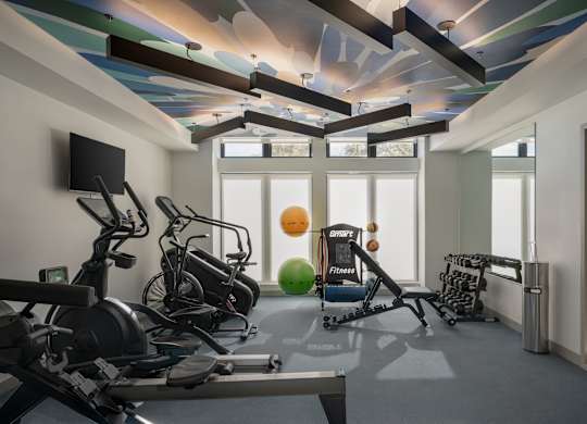 A gym with a variety of equipment including treadmills at The Park Apartments, Cleveland , OH, 44113