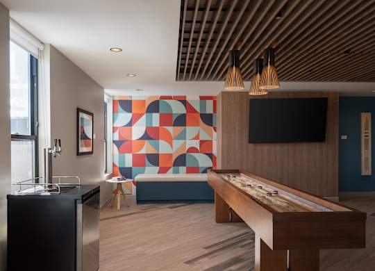 A room with a pool table and a bar at The Park Apartments, Cleveland 44113