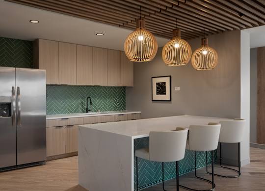 A kitchen with a white island and a refrigerator at The Park Apartments, Cleveland , OH, 44113