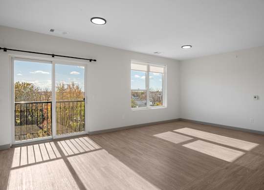 A room with a sliding glass door leading to a balcony at The Park Apartments, Cleveland , OH