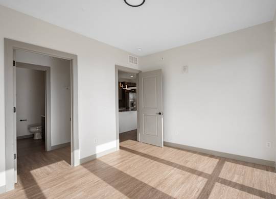A room with a toilet and a sink visible through the open door at The Park Apartments, Cleveland , Ohio