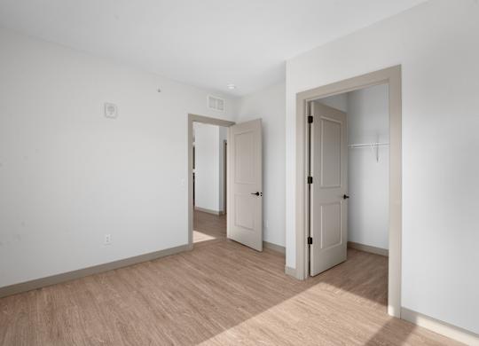 A room with two doors and a mirror at The Park Apartments, Ohio, 44113
