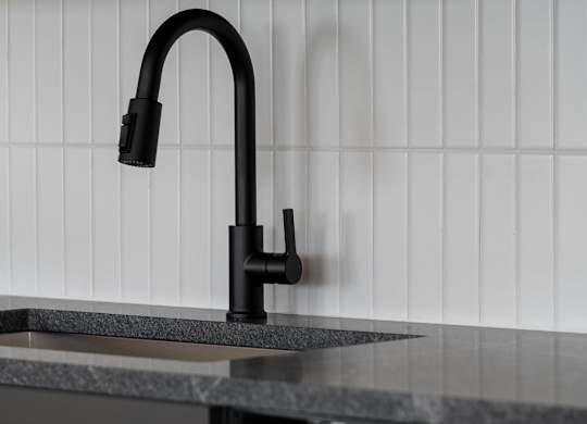 A black kitchen faucet with a pull out sprayer at The Park Apartments, Cleveland , Ohio