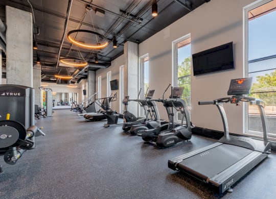 cardio equipment and a flat screen tv at TREO Apartments, Cleveland, 44116