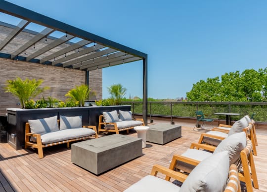 a rooftop deck with couches and a fire pit at TREO Apartments, Cleveland, 44116