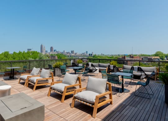 an outdoor deck with lounge chairs and a fire pit with a view of Cleveland TREO Apartments, Cleveland