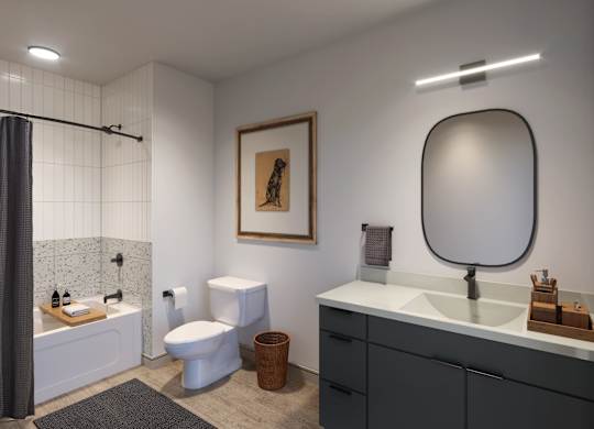 A bathroom with a white sink, toilet, and a large mirror.