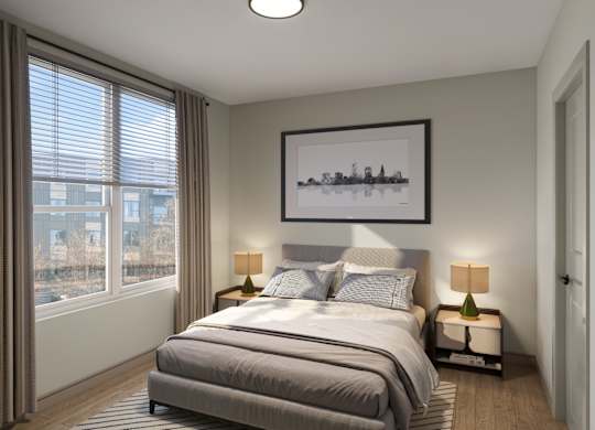 A bedroom with a large bed and a picture on the wall.