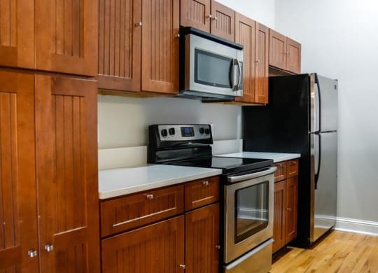 a kitchen with a refrigerator  stove and microwave