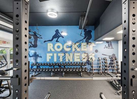 A gym with a blue wall and a sign that says