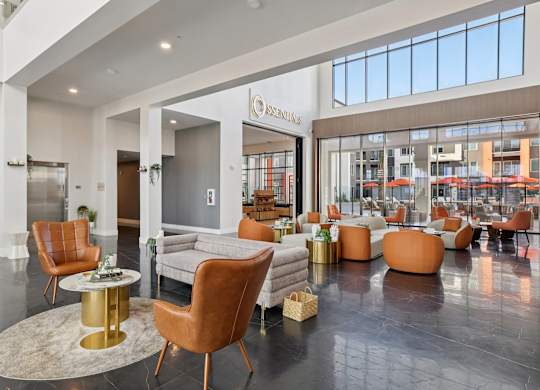 A living room with a large rug and a variety of chairs.