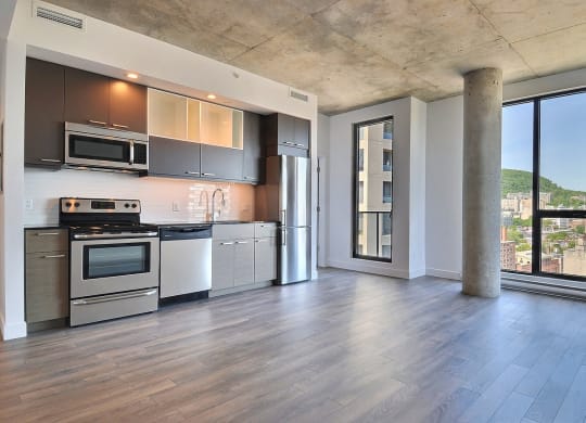 a kitchen with stainless steel appliances and a large window