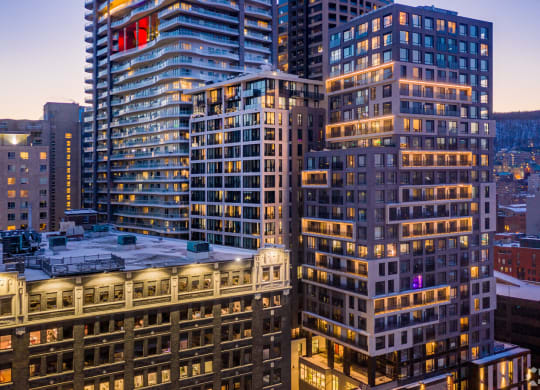 a view of skyscrapers in the city at dusk