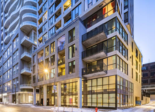a view of a building on a city street at dusk