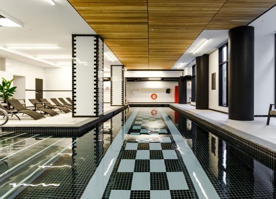 a large swimming pool with chairs in a lobby