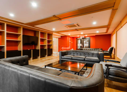 a living room with leather couches and a coffee table
