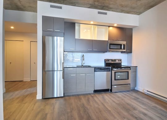 a kitchen with stainless steel appliances and a refrigerator