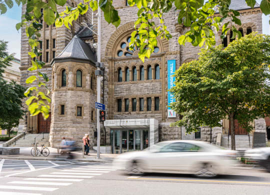 a car driving down a street in front of a building