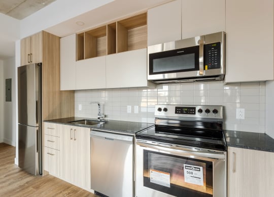 a kitchen with stainless steel appliances and white cabinets