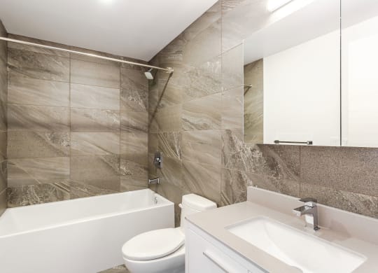 a bathroom with a sink toilet and a bath tub