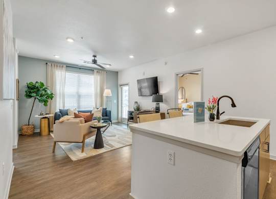 an open living room with a kitchen and a living room at Apex apartments in Colorado Springs, CO