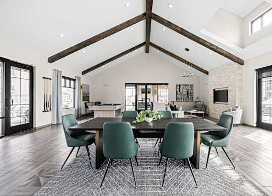 a large dining room with a large table and chairs