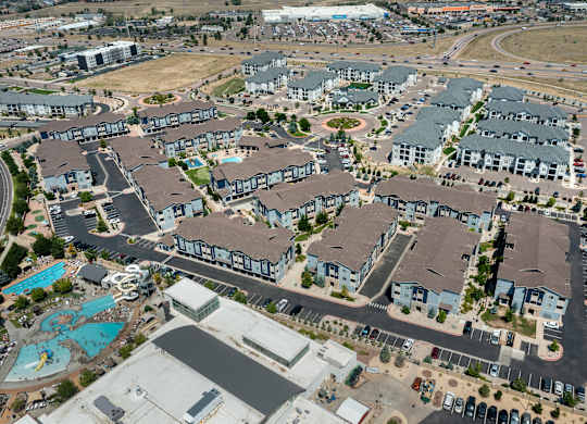 A bird's eye view of a residential complex with a swimming pool.