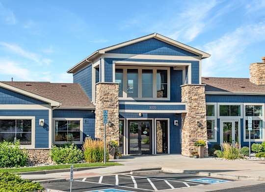 A blue building with a stone pillar in front.