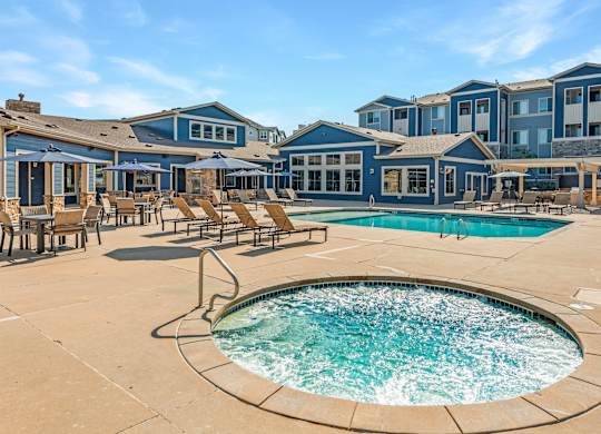 A large outdoor swimming pool surrounded by lounge chairs.