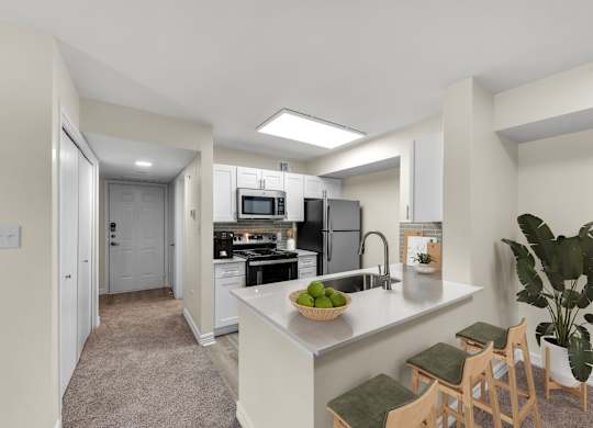 A kitchen with a refrigerator, stove, and sink.