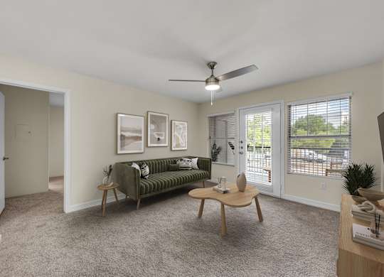 A living room with a green couch, a wooden coffee table, and a ceiling fan.